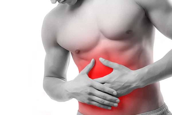 A man holding his abdomen with red highlighting, indicating lower abdominal pain