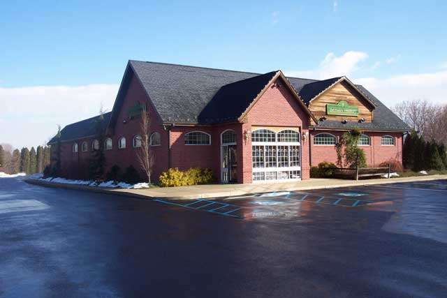 Exterior view of DelPrete Building with large front windows and a sloped roof