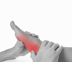 Hands massaging a foot, with red shading to indicate foot pain