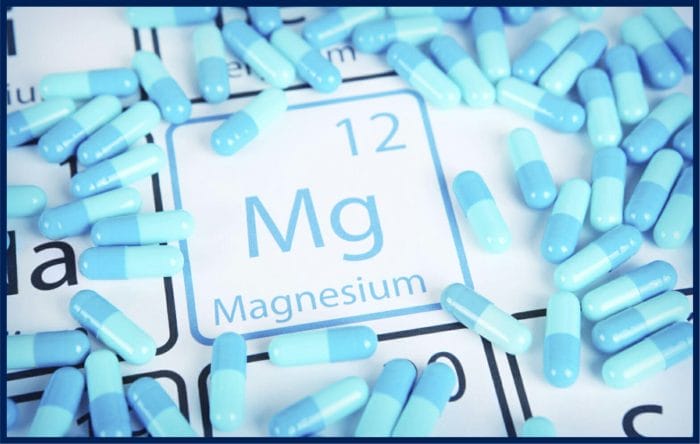 Periodic table element: Magnesium (Mg). Atomic number 12, symbol Mg. and lots of tablets of Magnesium.