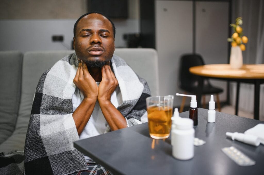 Sick African man with sore throat Portrait of ill black man suffering from sore throat due to cold, flu, allergy, polluted air, dust, smog air pollution sickness concept African man model